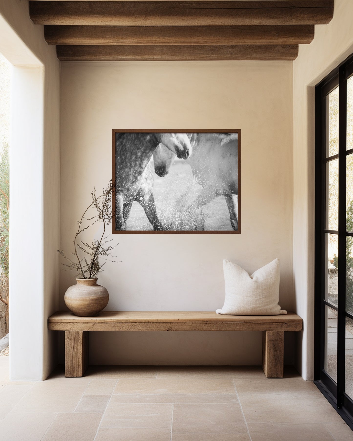 framed photo of two grey horses splashing in water in hallway