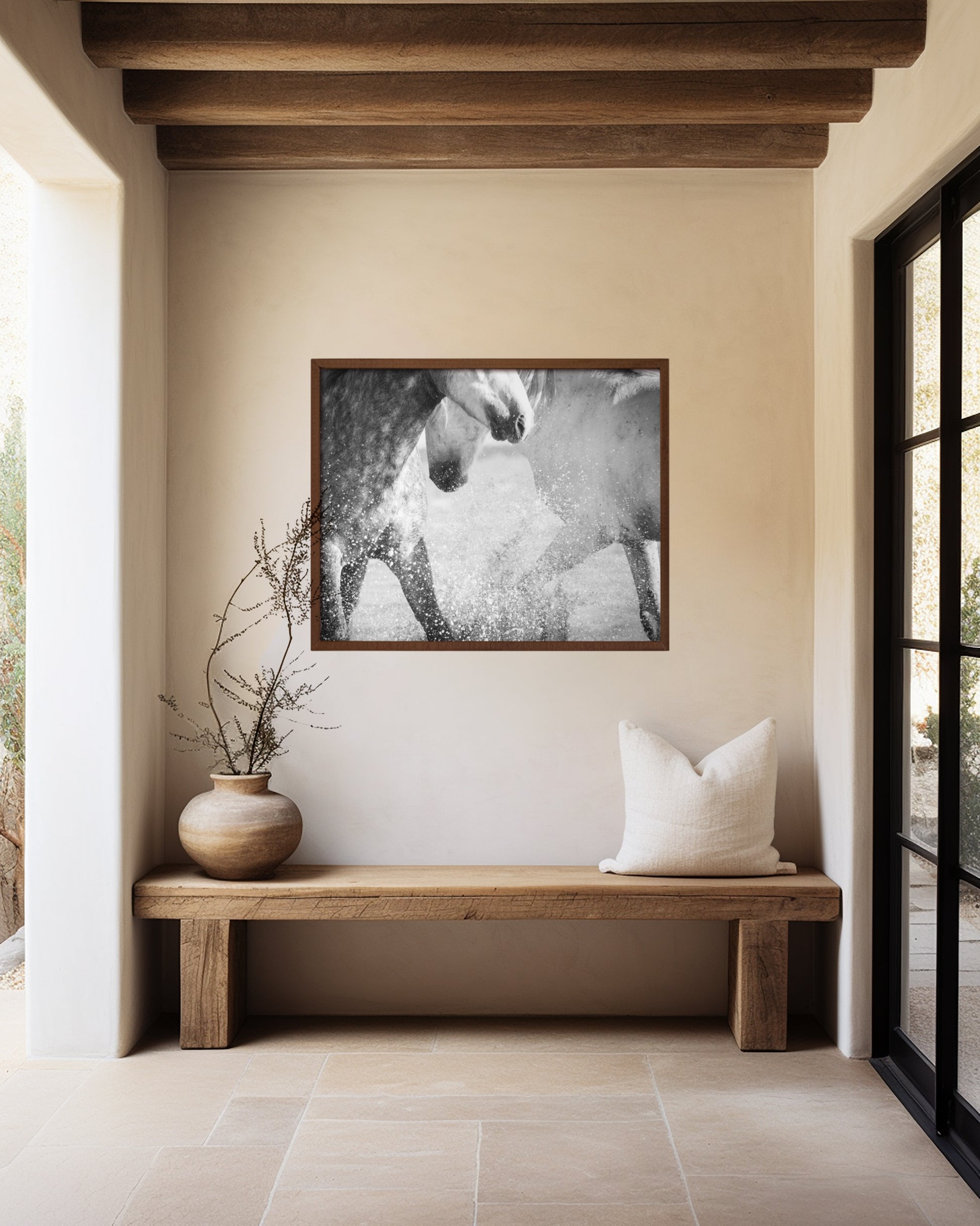 framed photo of two grey horses splashing in water in hallway