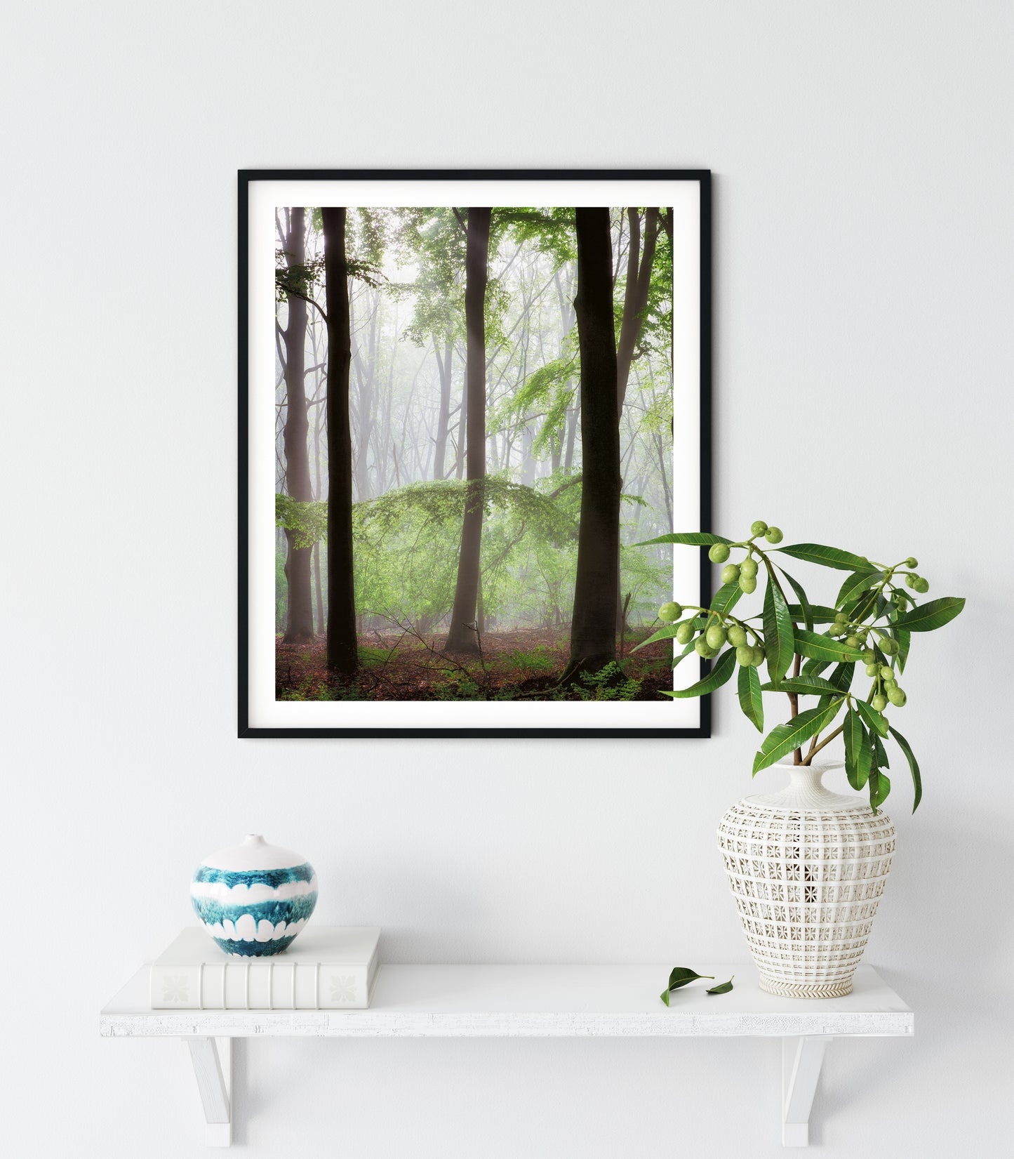 framed print of trees in forest on a wall
