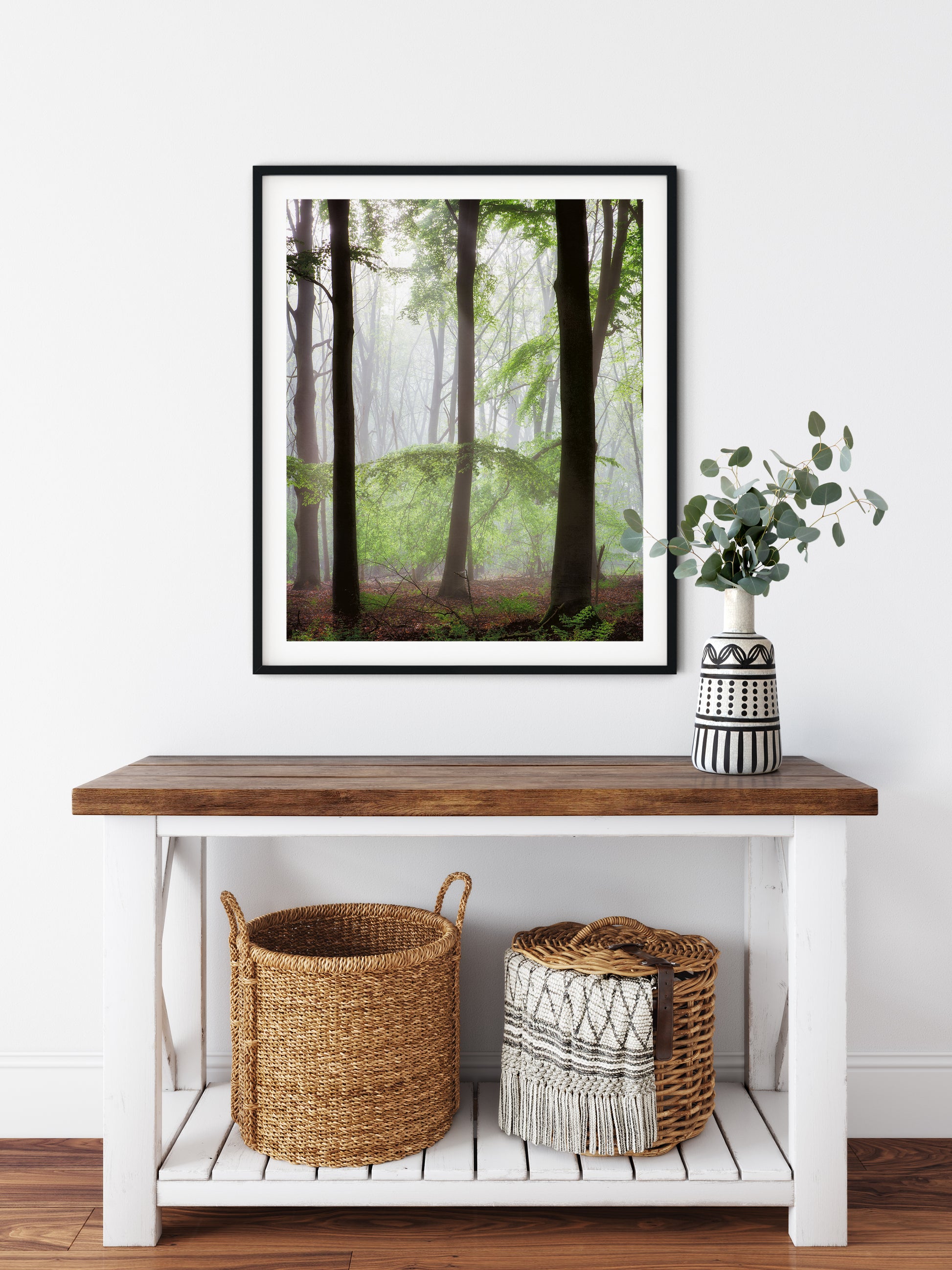 framed print of trees in a forest in a hallway